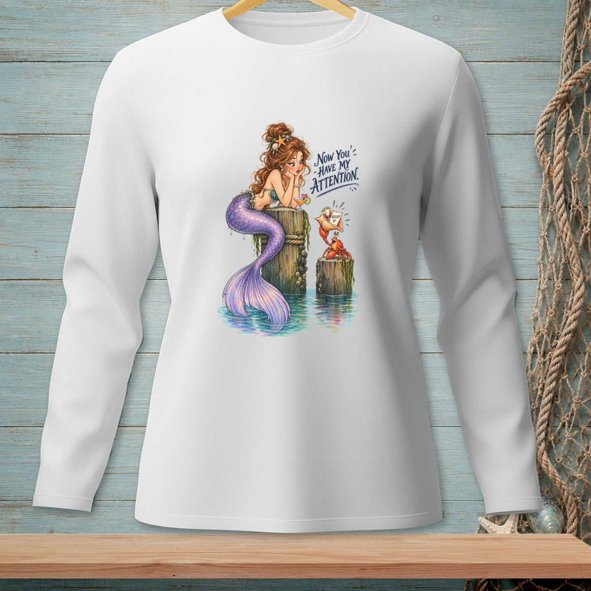 Mermaid with purple tail sits on a post, a crab offers gossip, text reads "Now You've Have My Attention."