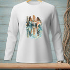 Three mermaids sit on a dock, with reflections in the water.