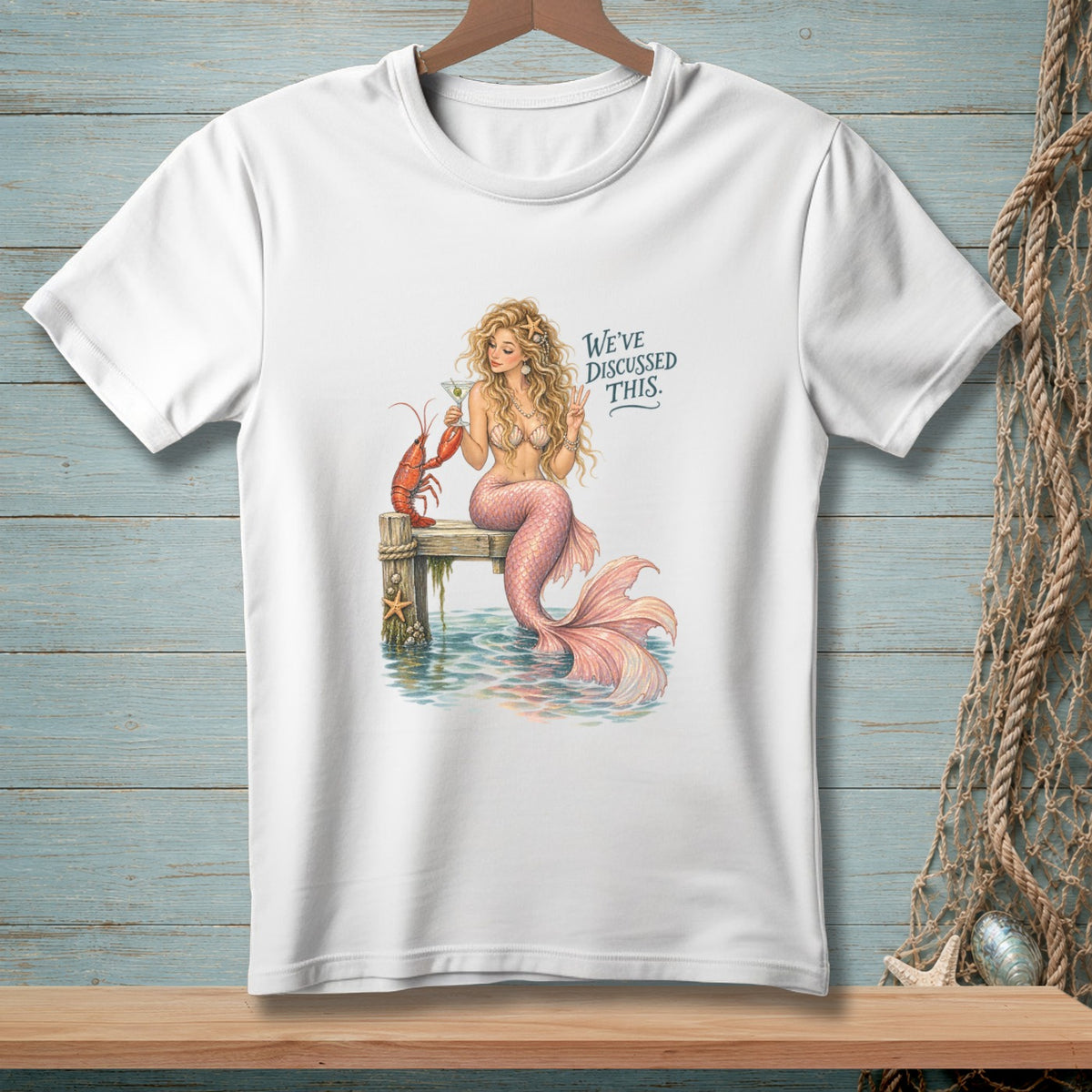 Mermaid with lobster and drink on dock, text "We've Discussed This."