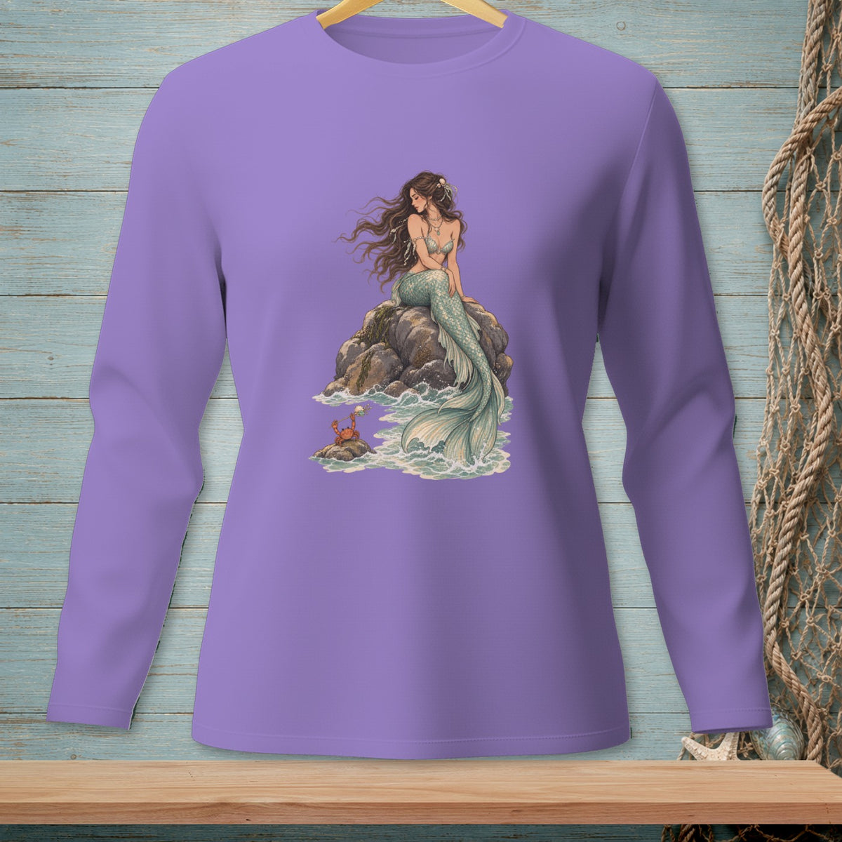 Purple long-sleeved shirt with a mermaid sitting on rocks with a crab.