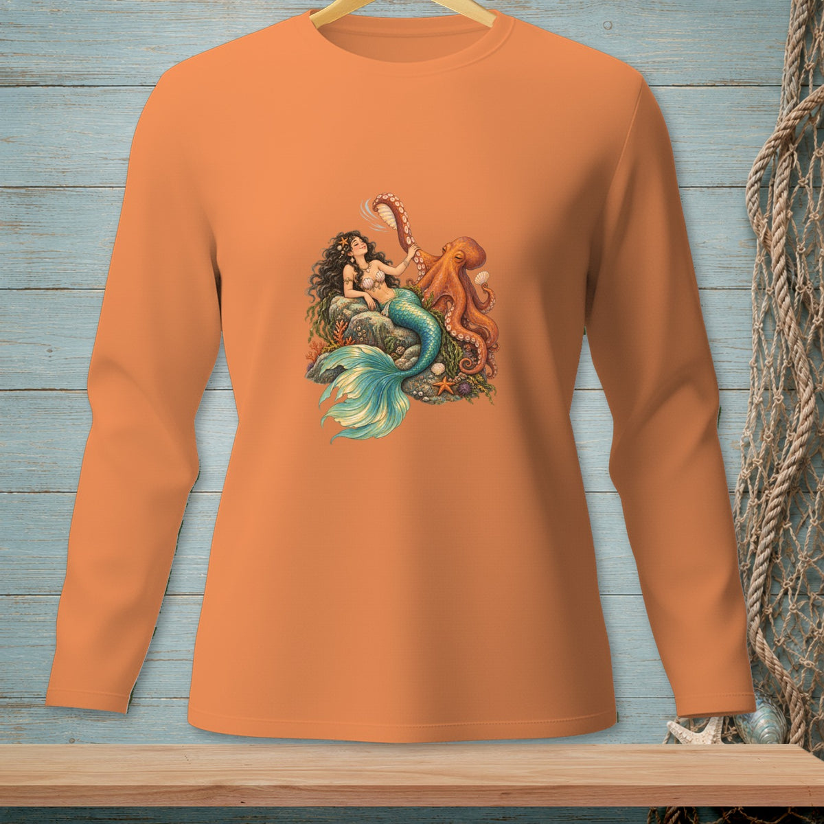 Long sleeve orange shirt with a detailed mermaid and octopus graphic.