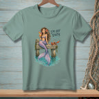 Illustration of mermaid with drink and crab on dock with text "I'M OFF DUTY".