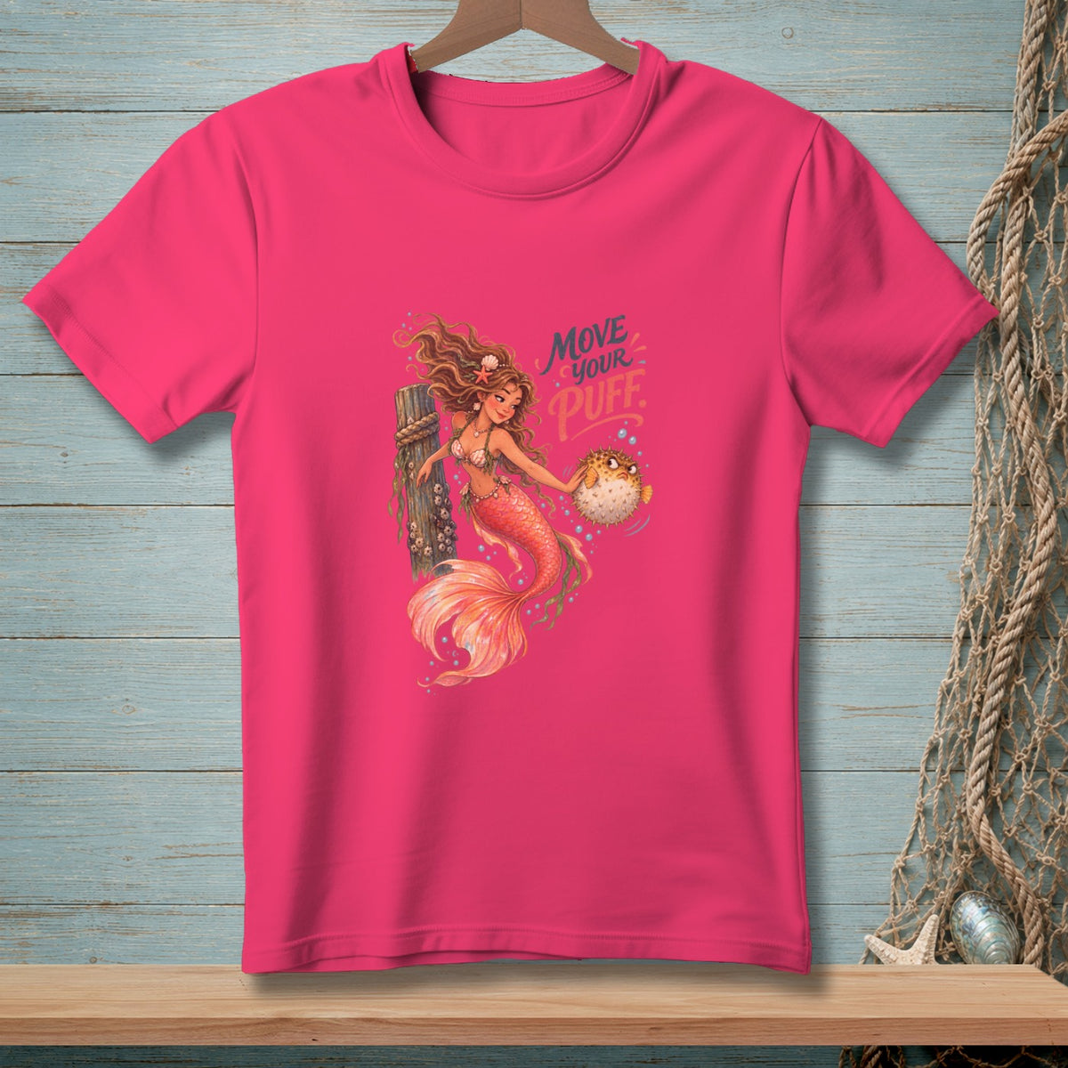 Pink t-shirt featuring a mermaid holding a pufferfish and text reading "Move Your Puff."