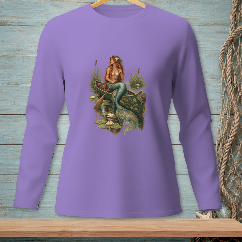 Mermaid in a canoe on water with lily pads, text "Taking The Scenic Route".