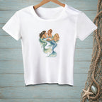White t-shirt with illustration of three mermaids drinking at a circular table.
