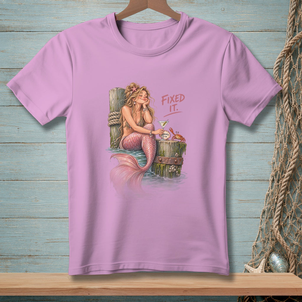Mermaid with cocktail and crab on a pier, text "Fixed It."