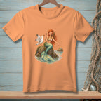 Mermaid sitting on rocks with seagull and pearl, on an orange t-shirt.