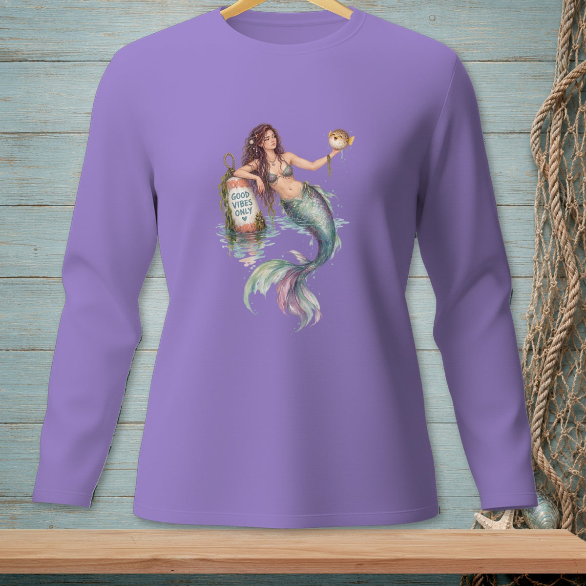 Mermaid holding a pufferfish near a buoy reading "Good Vibes Only".