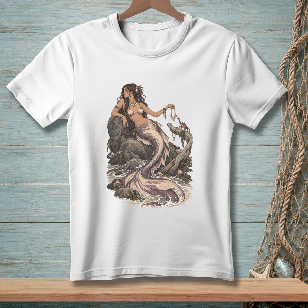 White t-shirt with a seated mermaid illustration, holding a crab.