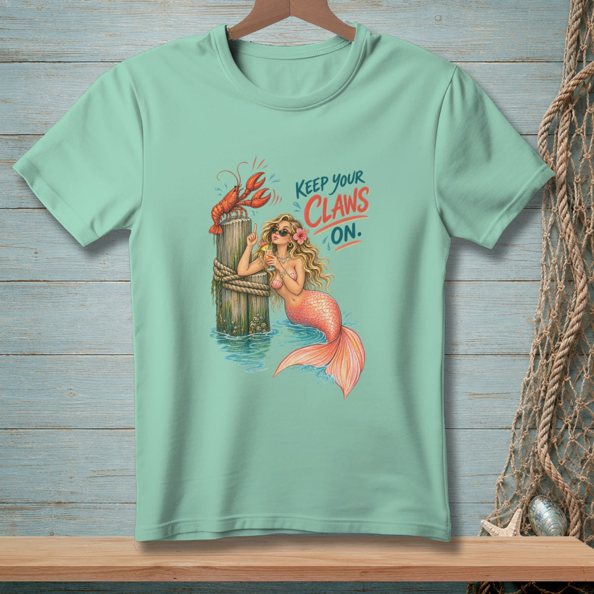 Mermaid with lobster and text "Keep your claws on."
