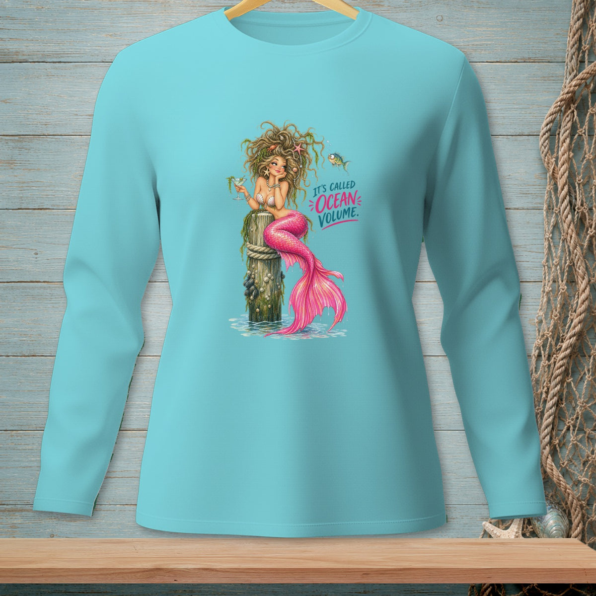 Mermaid sitting on a post with pink tail, text "It's Called Ocean Volume."