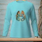 Two mermaids with tails sit talking on a wooden dock in ocean water.