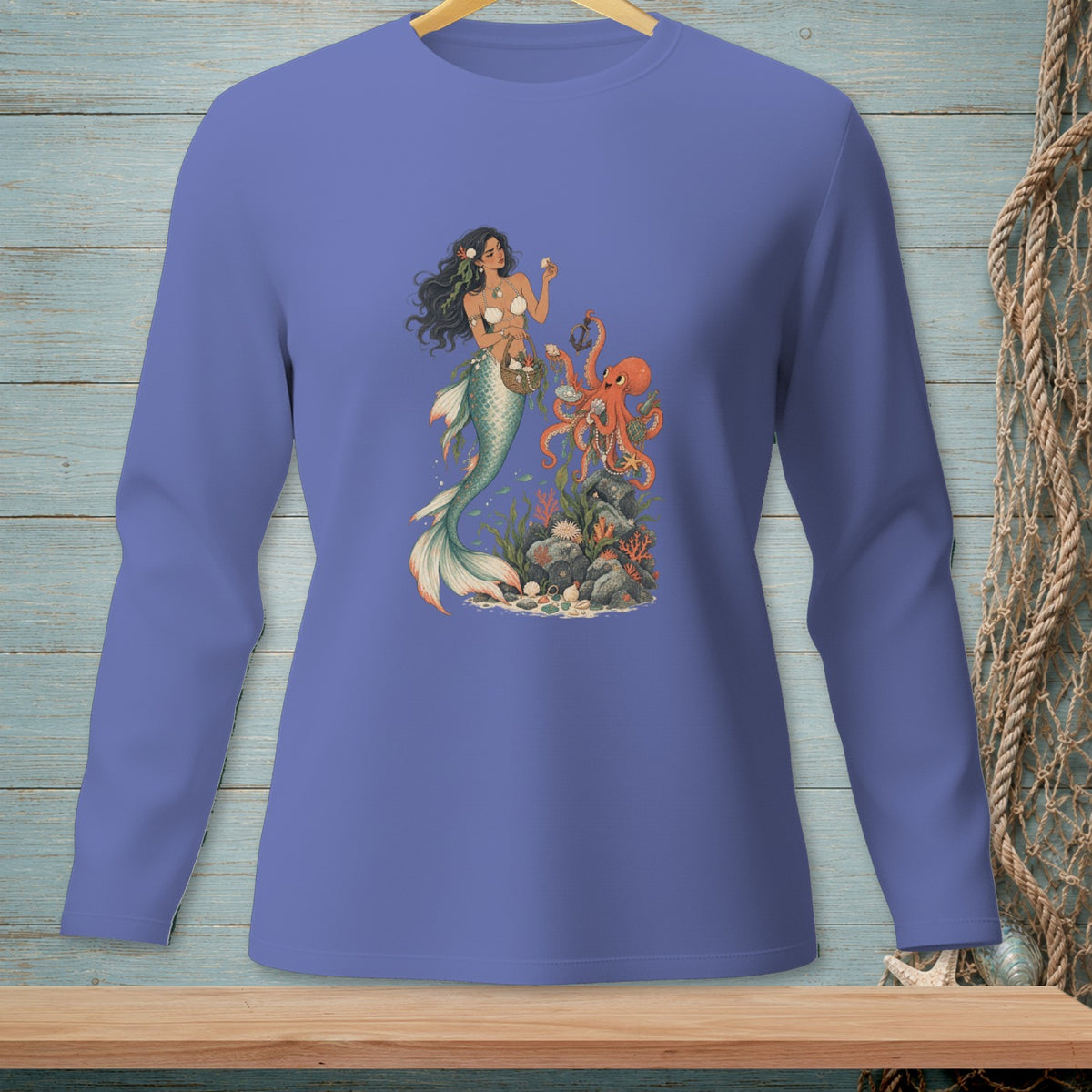 Mermaid holding seashell, octopus and underwater scene printed on a purple long-sleeve shirt.