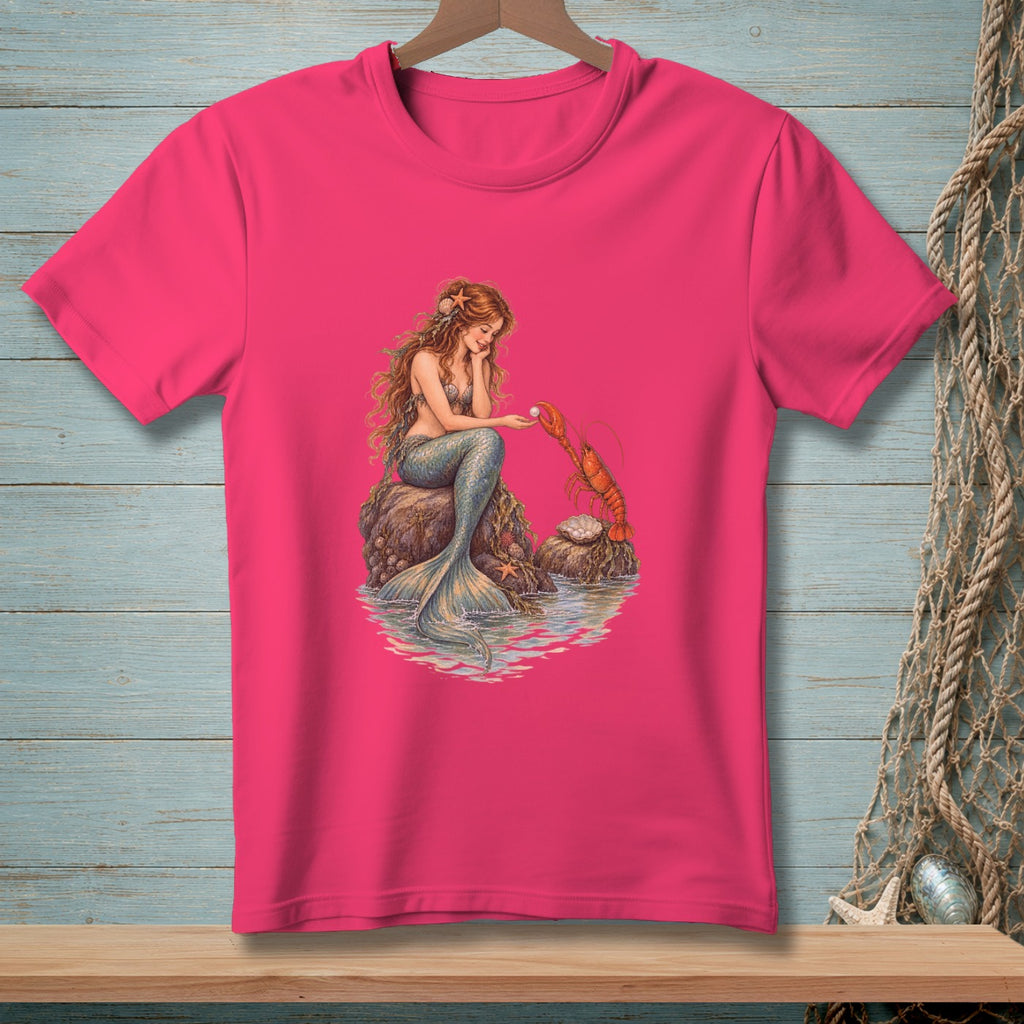 Mermaid sitting on a rock reaching for a lobster on a pink t-shirt.