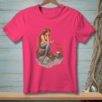 Mermaid sitting on a rock reaching for a lobster on a pink t-shirt.