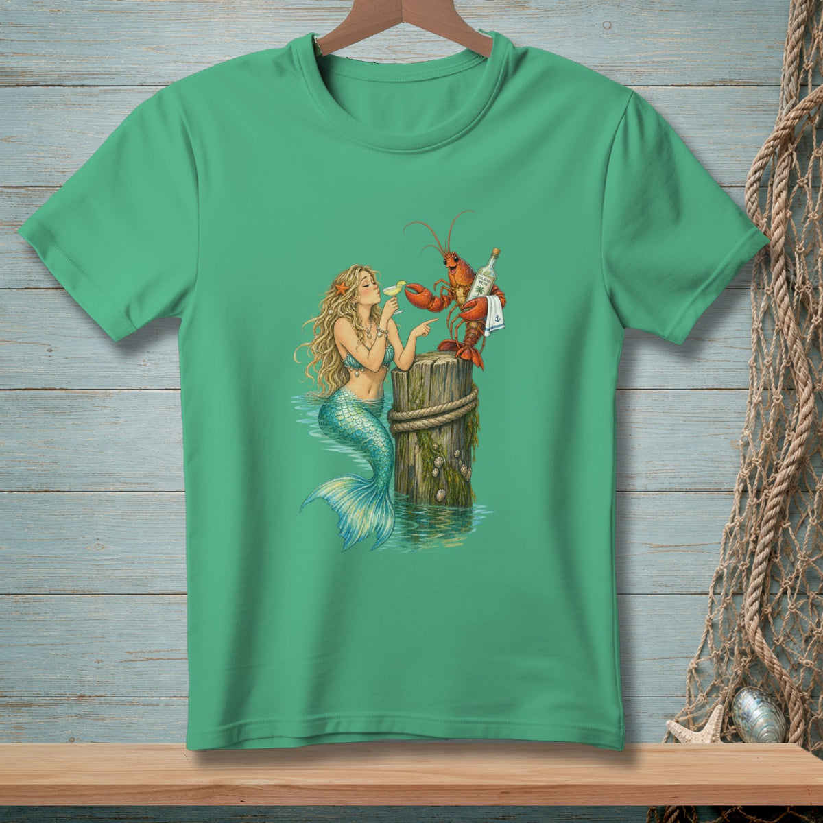 Mermaid and lobster with drinks at a dock post illustration on a green t-shirt.