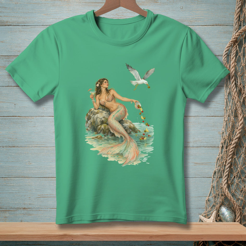 Mermaid sitting on a rock with a seagull flying overhead, green t-shirt graphic.