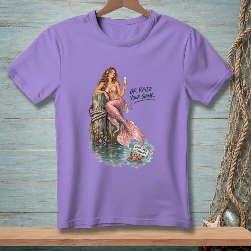 Mermaid on piling with champagne, text "OR RAISE YOUR GAME." Crab holds "LOWER YOUR STANDARDS."