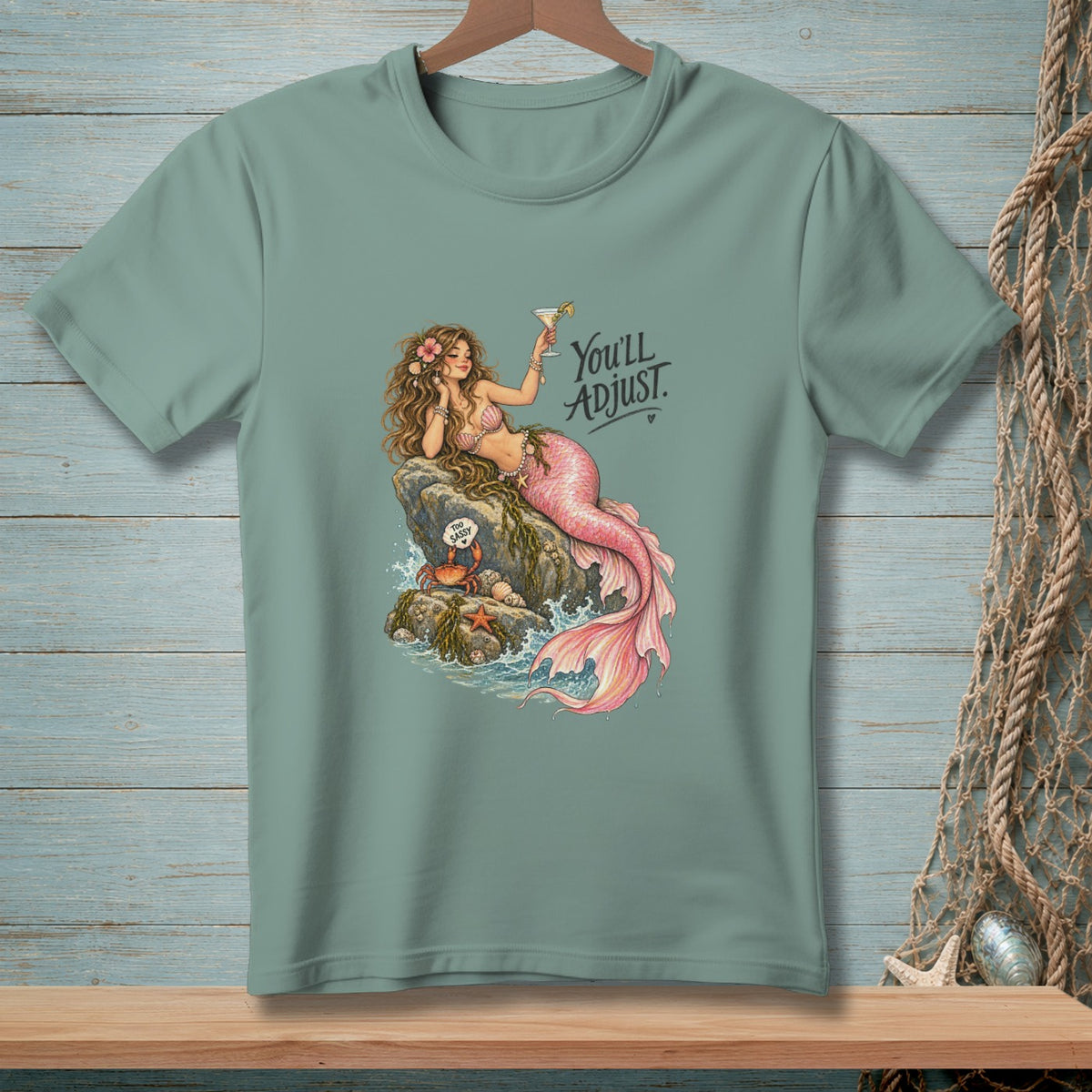 Mermaid holding a cocktail on a rock with a crab, text "You'll Adjust."