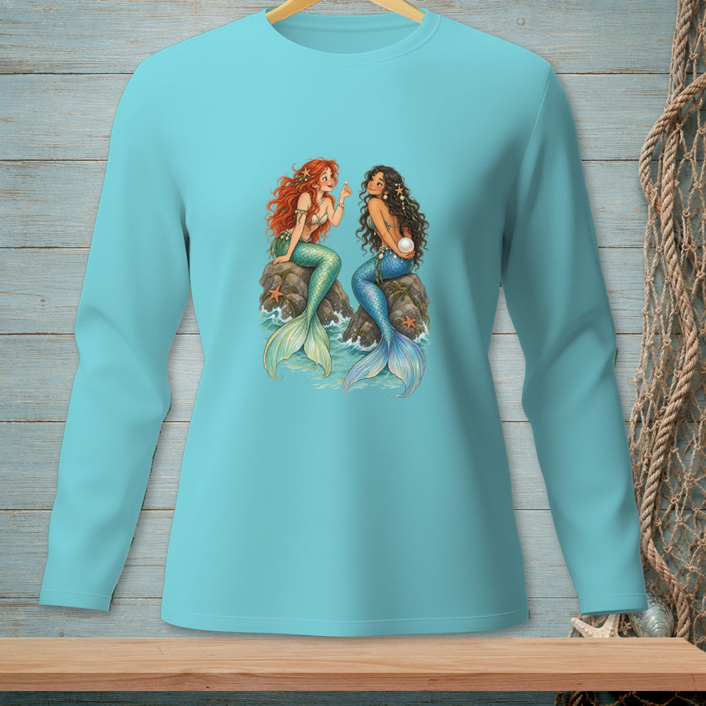 Two mermaids with tails are sitting on rocks, one with red hair and one with dark hair.
