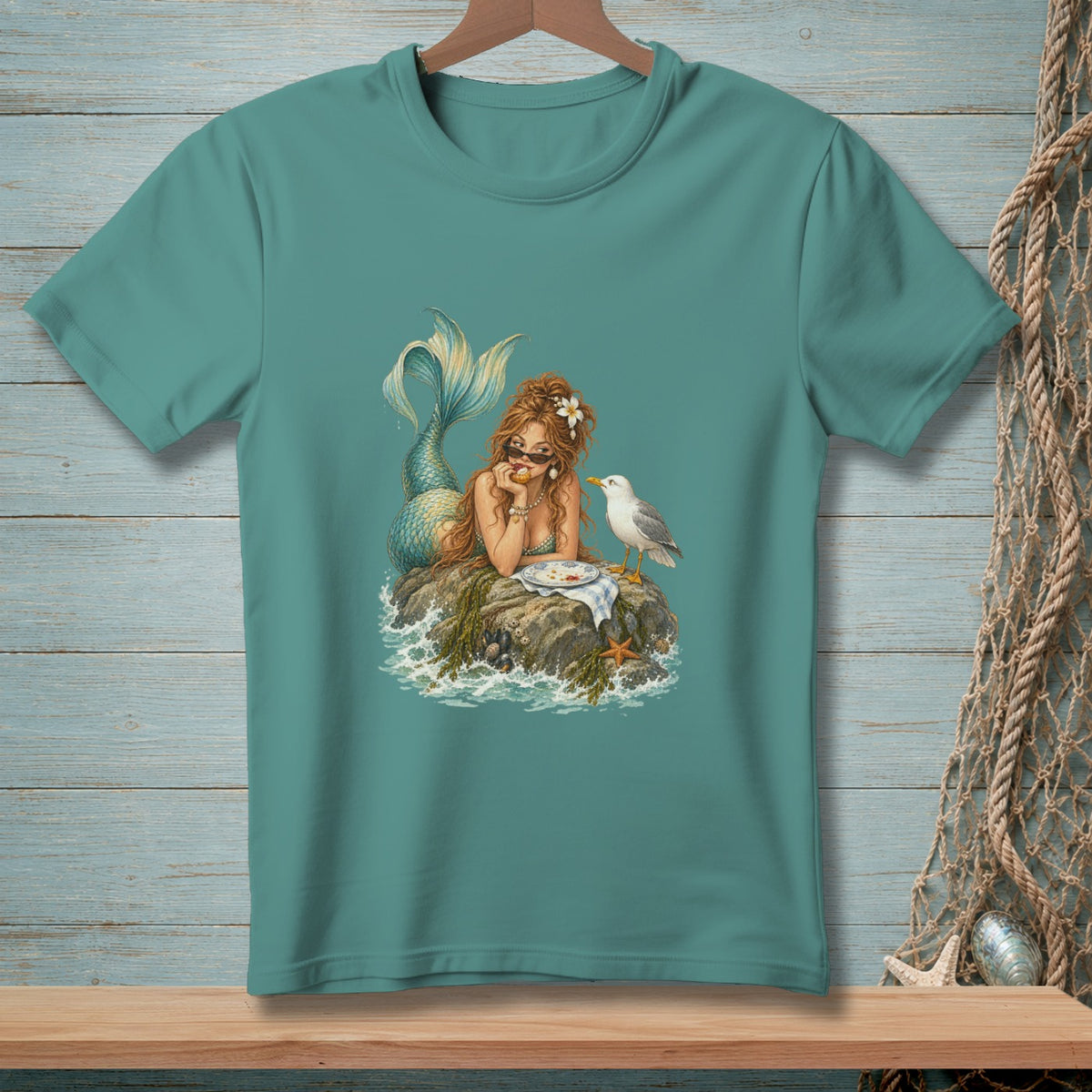 Illustration of a mermaid eating with a seagull on a rock.