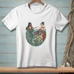 Illustration of three mermaids in a circular design on a white t-shirt.