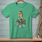 Green t-shirt featuring a mermaid holding a seashell, seated on a rock.