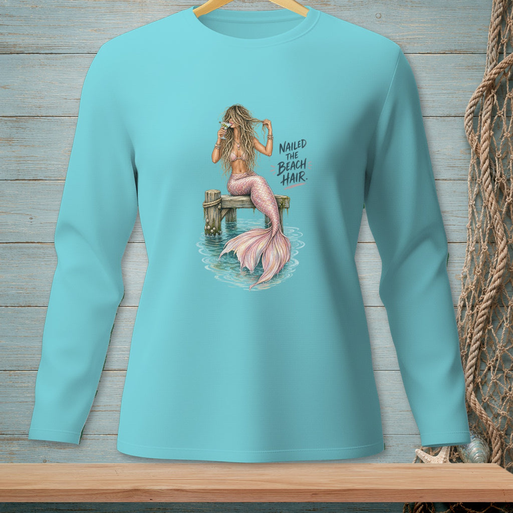 Mermaid on pier with drink and text "NAILED THE BEACH HAIR."