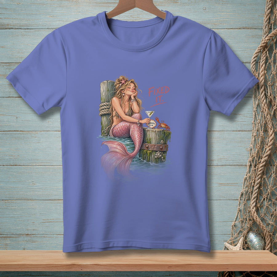 Mermaid relaxing with a drink and a crab, text "Fixed It".