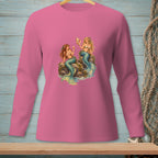 Pink long sleeve shirt with two mermaids sitting on rocks with a seashell.