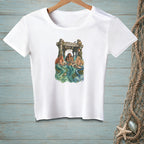 White t-shirt with three mermaids reading under a pier, with text "Current Reading".
