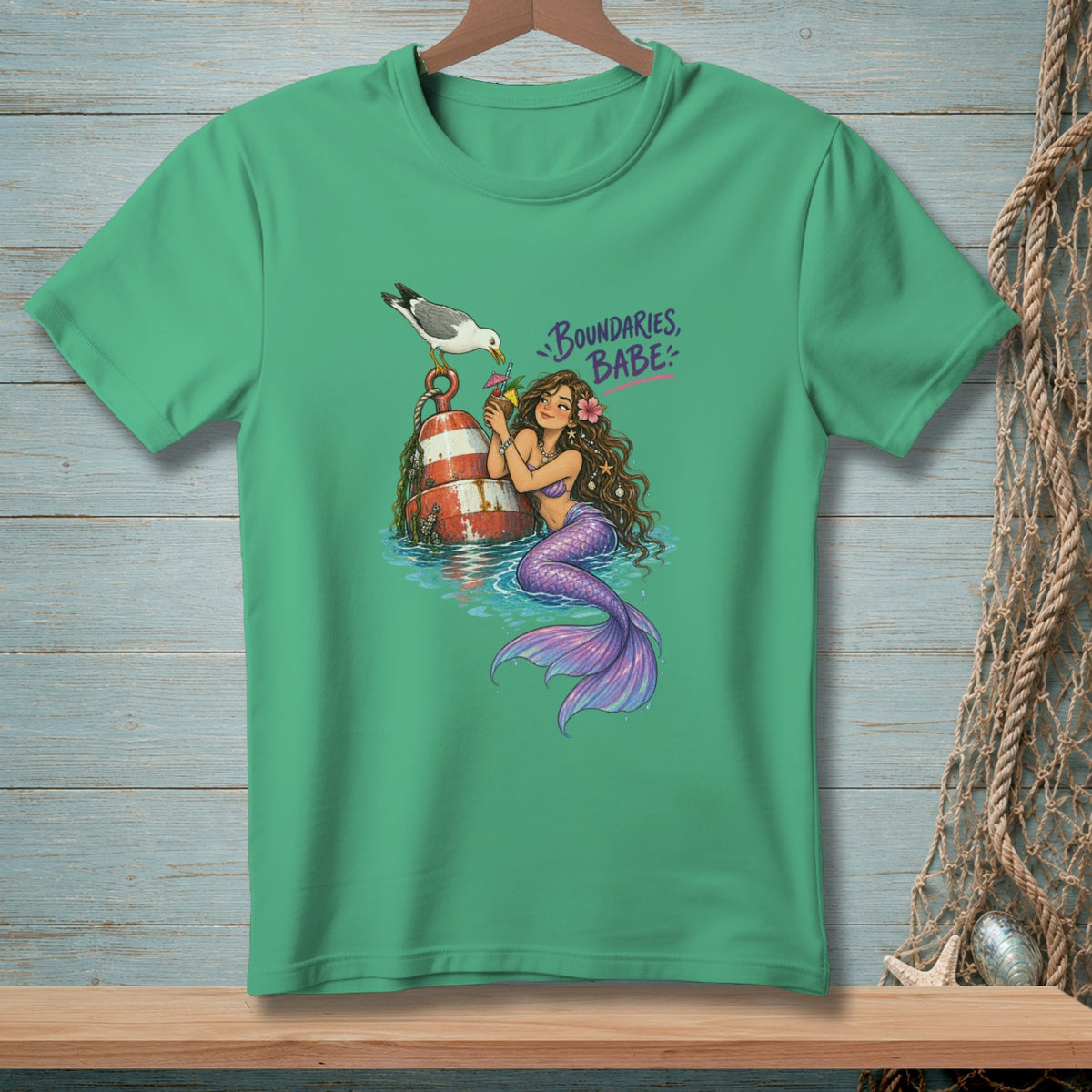 Green t-shirt with a mermaid, buoy, seagull, and text "Boundaries, Babe."