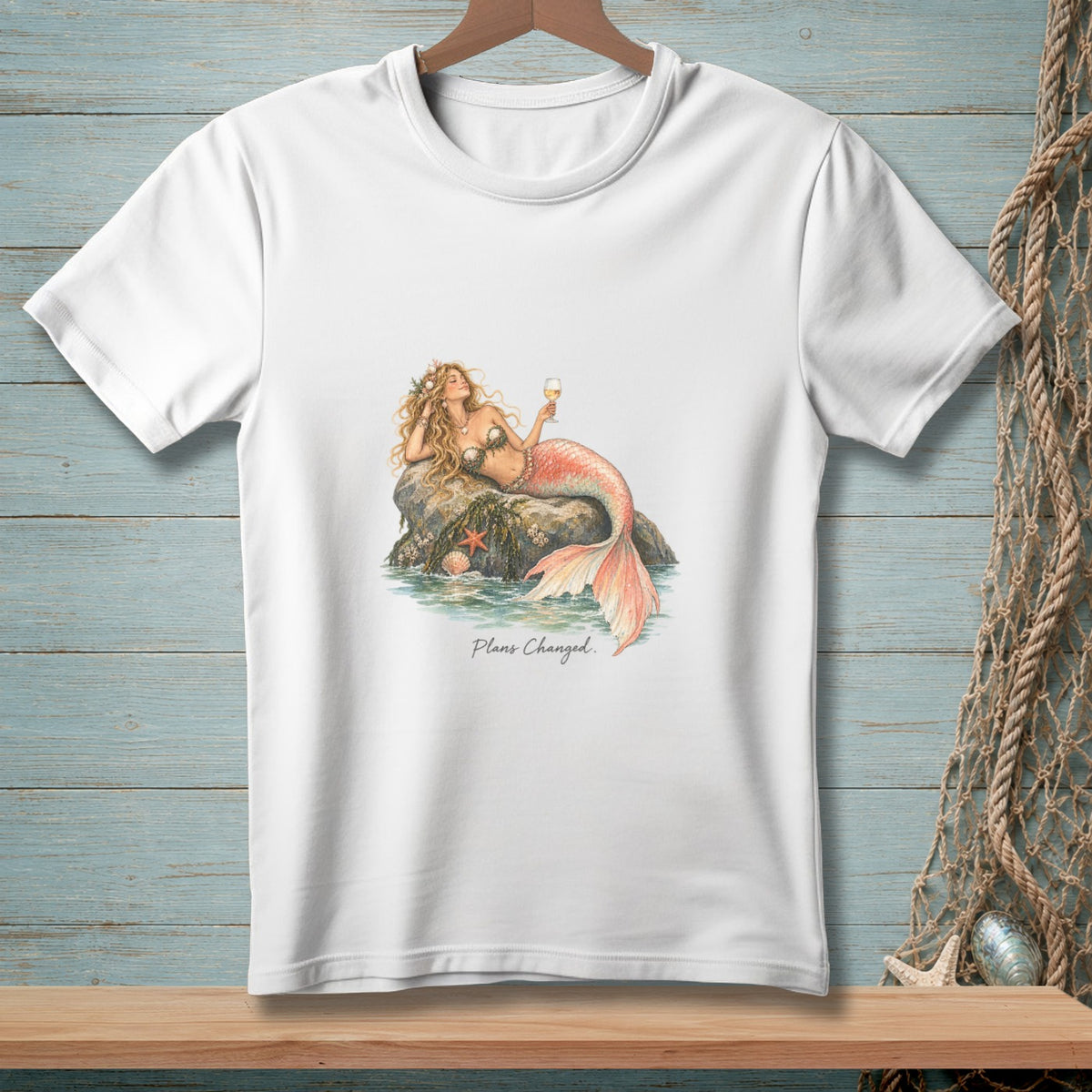 White t-shirt with a mermaid on a rock, holding a drink, with text "Plans Changed."
