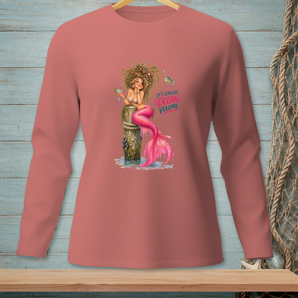 Mermaid with pink tail holding a drink, text "It's called Ocean Volume".
