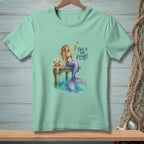 Mermaid with cocktail on dock, with crab and text "This is the effort".