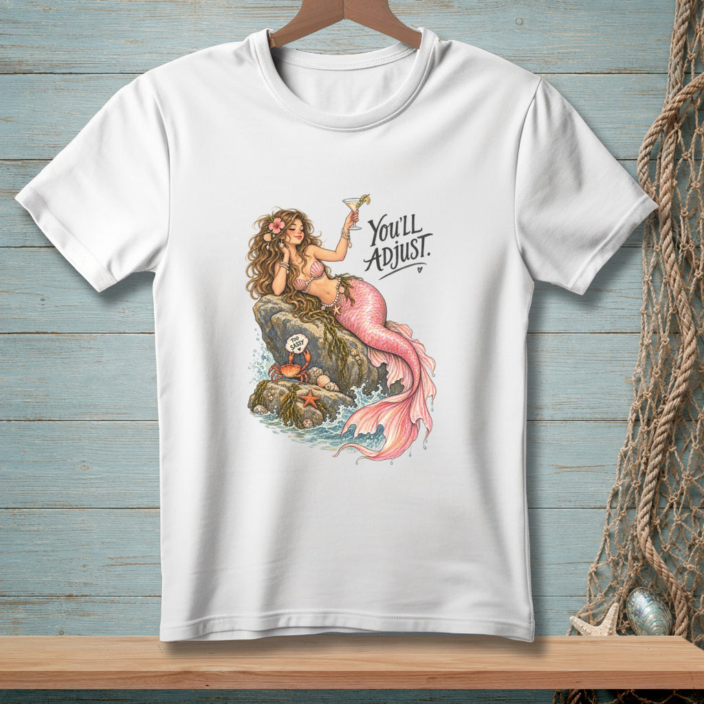 White t-shirt graphic with a mermaid holding a cocktail and text "You'll Adjust."