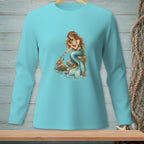Turquoise long-sleeve shirt with mermaid, crab, and pearl graphic on a rock.