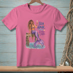 Pink t-shirt with mermaid illustration and text "Sea Hair Zero Care".