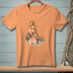 Orange t-shirt with a detailed illustration of a mermaid and crab on rocks.