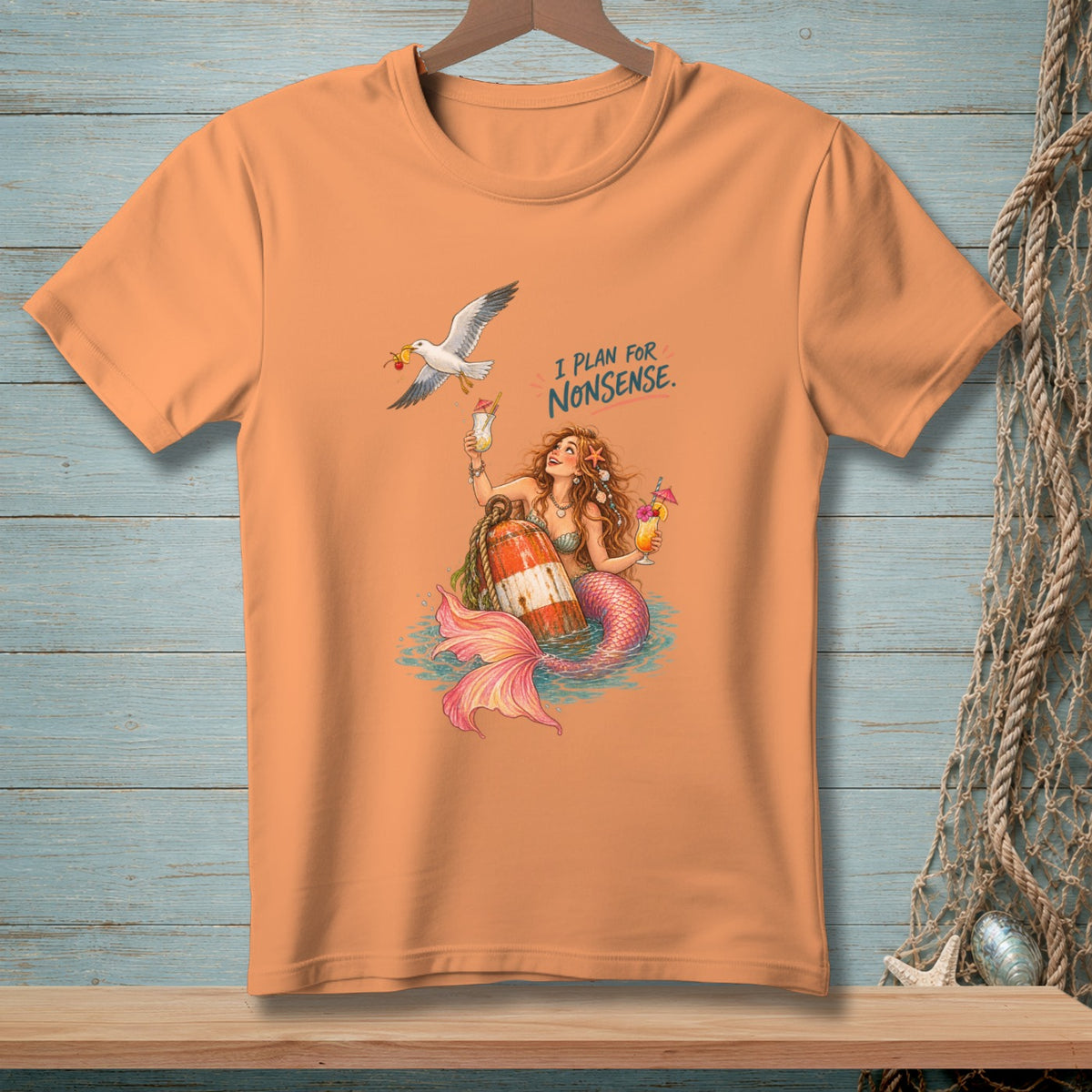 Orange t-shirt with mermaid, buoy, seagull, and text "I PLAN FOR NONSENSE."