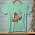 Illustration of a mermaid eating with a seagull on a rock.