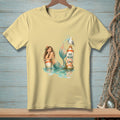 Light yellow t-shirt with a mermaid and seagull by a "No Wake" sign.