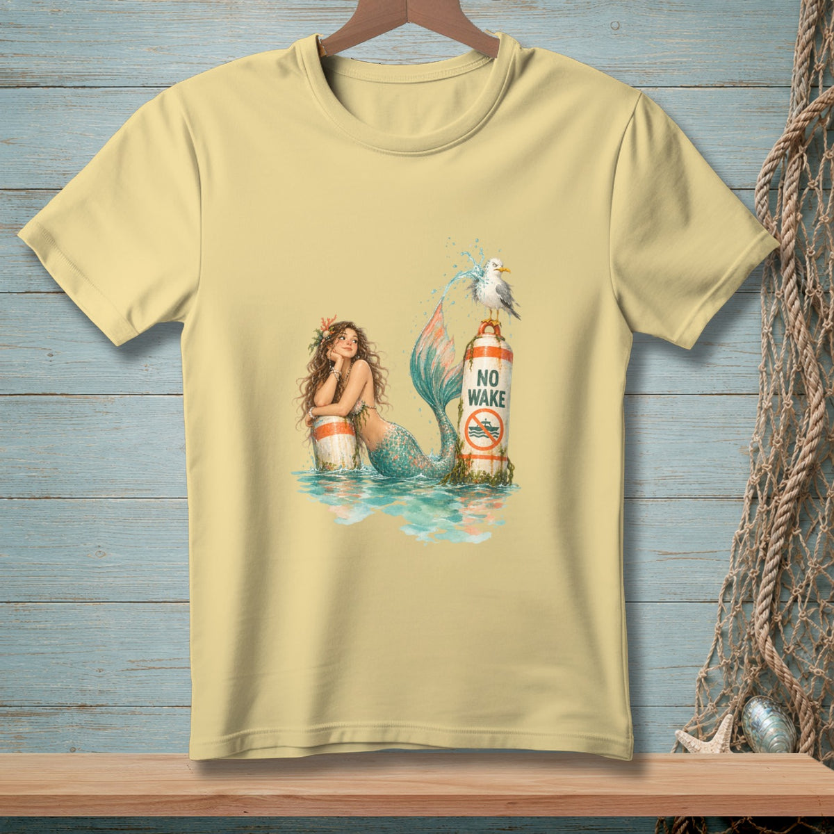 Light yellow t-shirt with a mermaid and seagull by a "No Wake" sign.