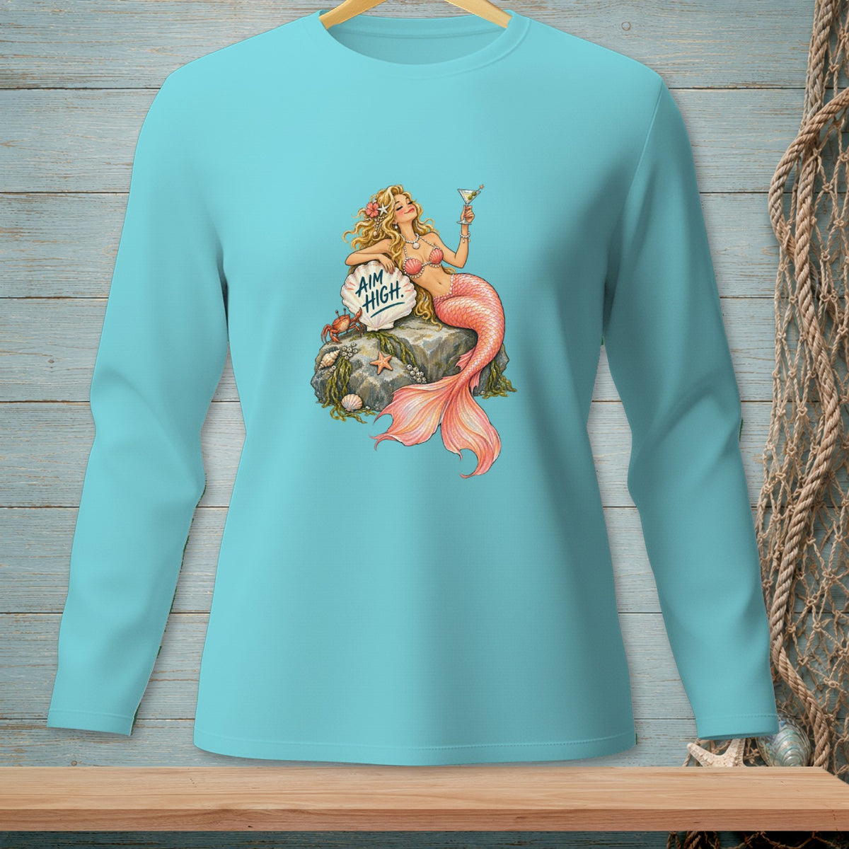 Turquoise long sleeve shirt with a mermaid holding a martini and the text "AIM HIGH".