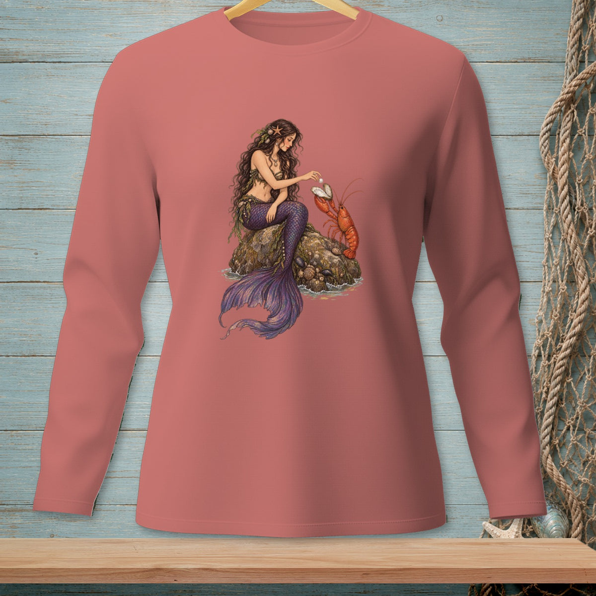 Illustration of a mermaid with a lobster, printed on a coral long-sleeve shirt.