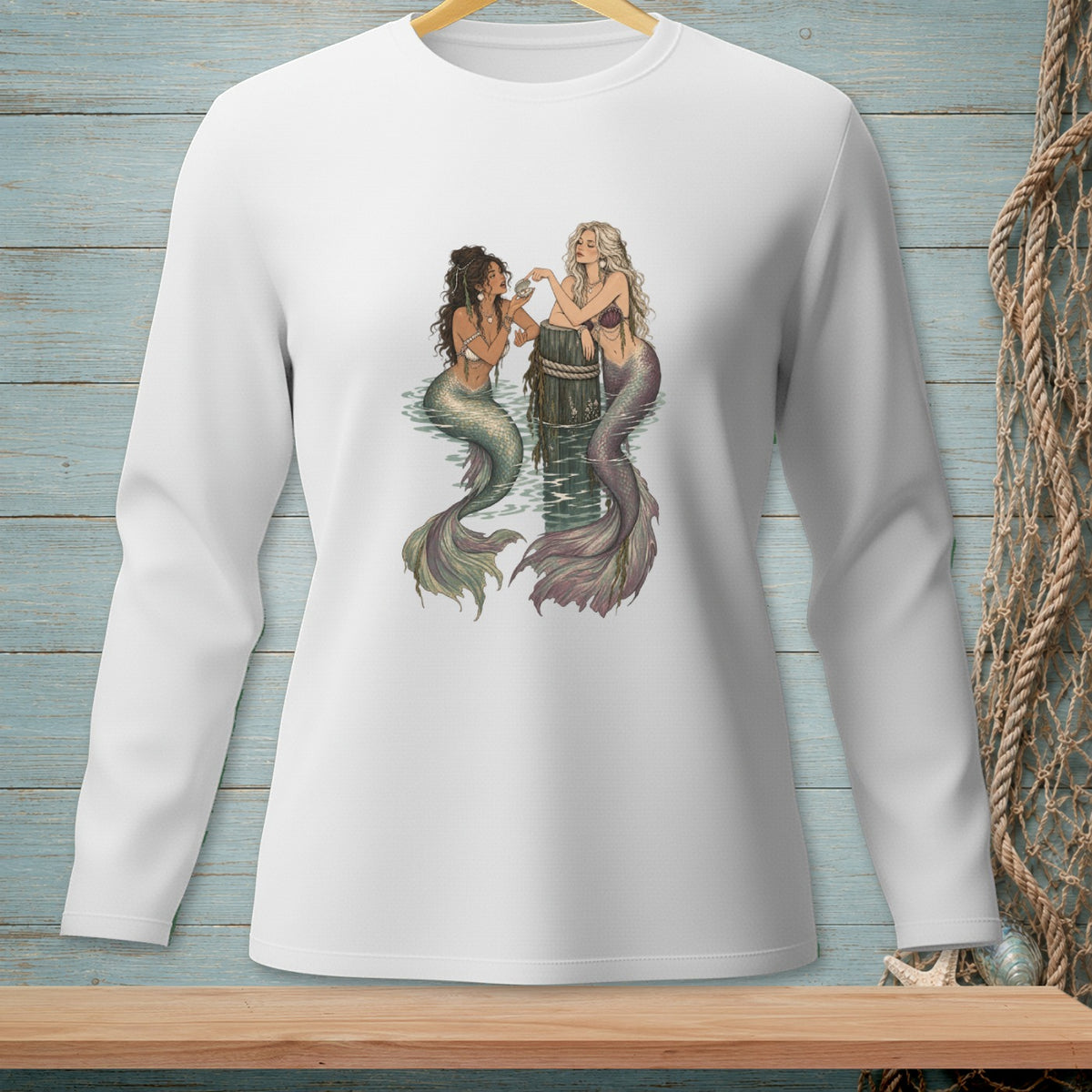Two mermaids with colorful tails interact by a wooden post in the water.