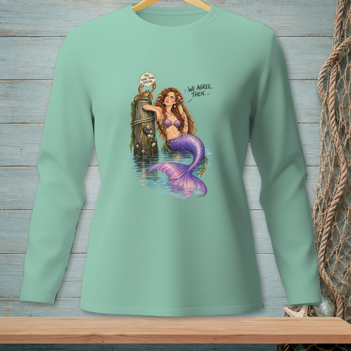 Mermaid holding champagne with a crab on a post, text "WE AGREE, THEN."