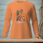 Orange long-sleeve shirt with mermaid and crab graphic on wooden background.