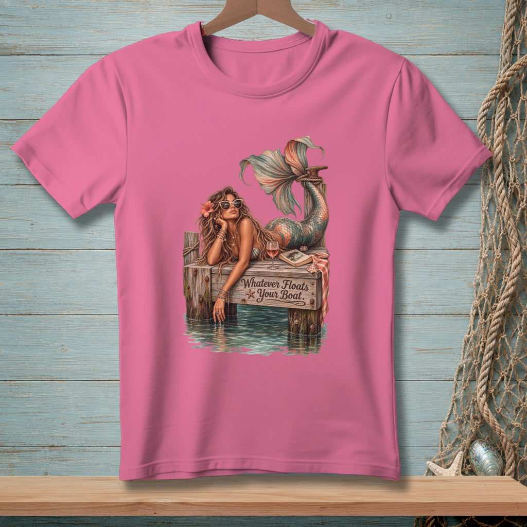 Pink t-shirt with mermaid on dock graphic and "Whatever Floats Your Boat." text.