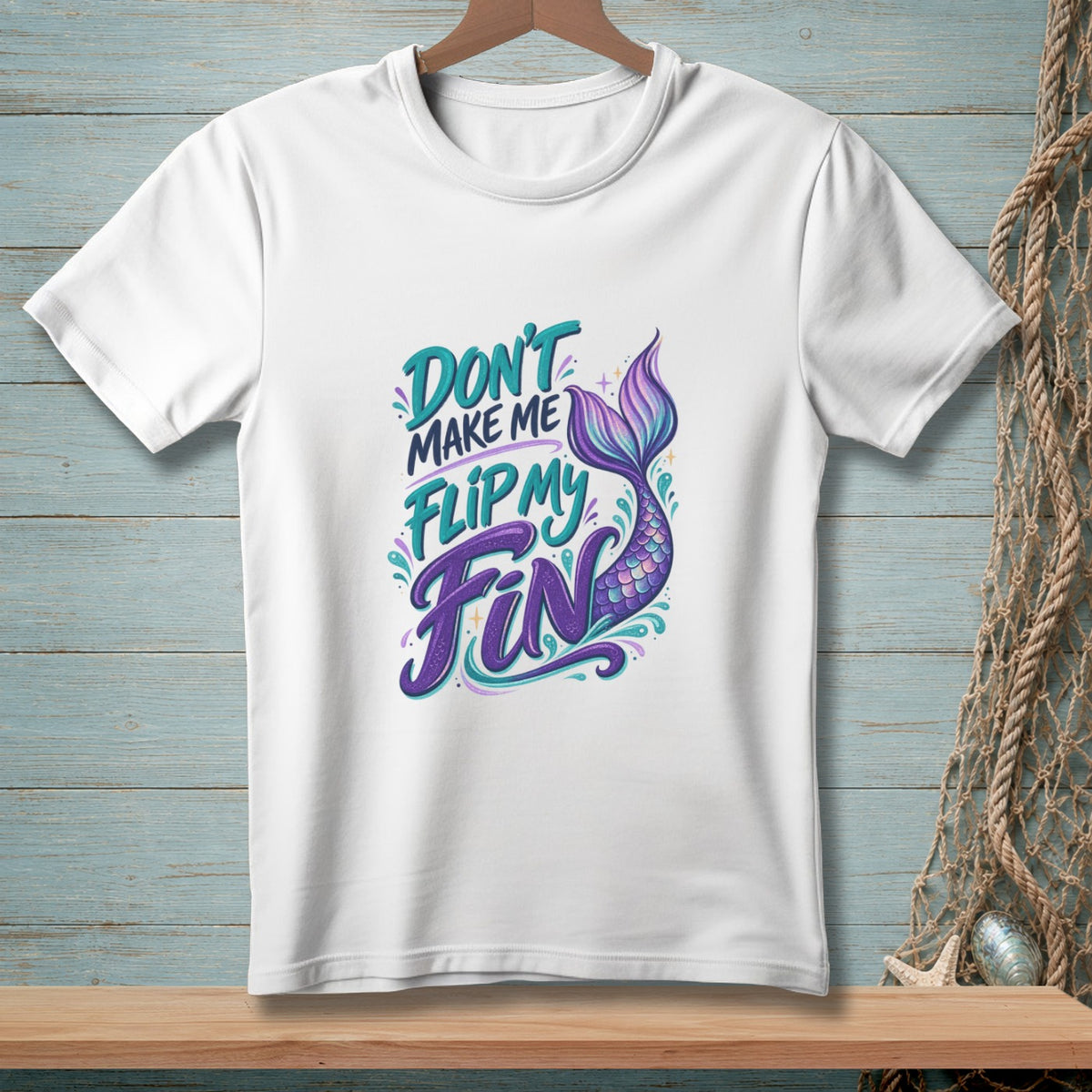 White t-shirt with "Don't Make Me Flip My Fin" text and mermaid tail graphic.